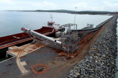 Ore conveyed along causeway and onto barge